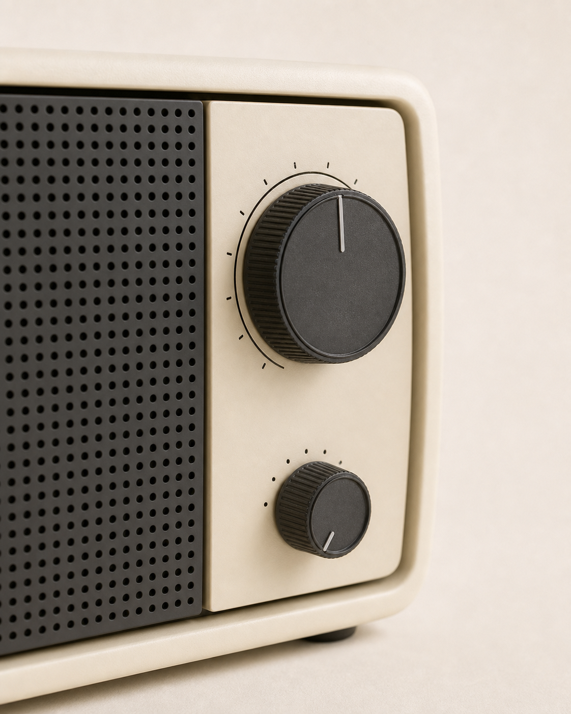 Close front view of the Braun table radio showing its charcoal control knobs and perforated speaker grille