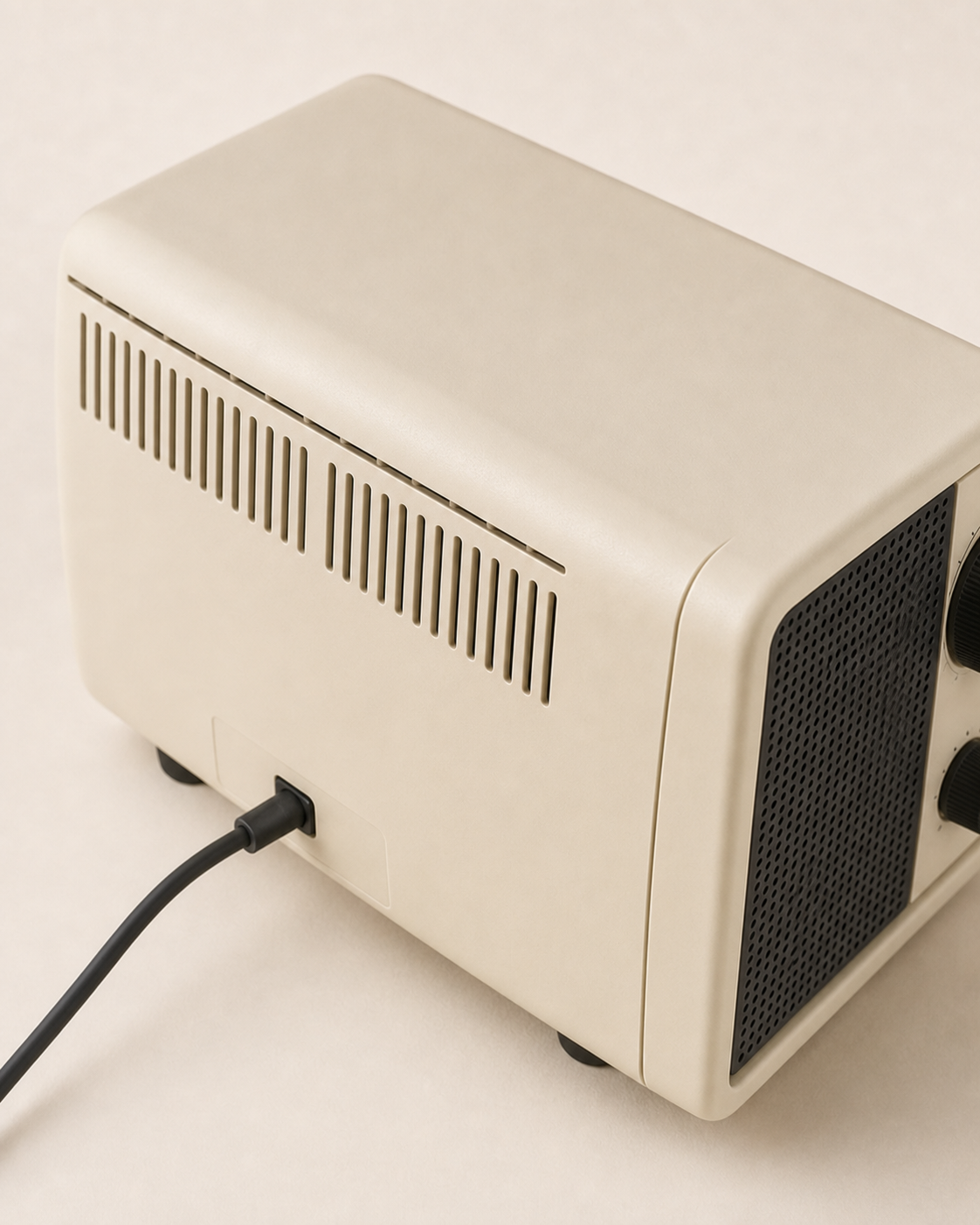 Elevated rear view of the Braun table radio showing its rounded cabinet, ventilation slots and power lead